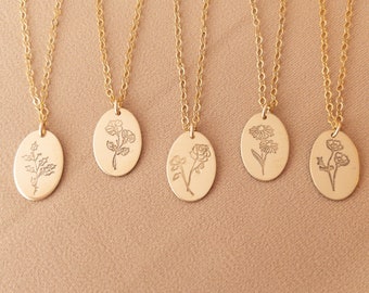 May include: Five gold necklaces with oval pendants featuring different floral designs. Each pendant has a delicate etched floral pattern.