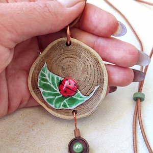 MEDALLION handmade LADYBUG, jewelry made of NATURAL materials, hand-painted on wood, three-dimensional beetle on a leaf, art gift for her