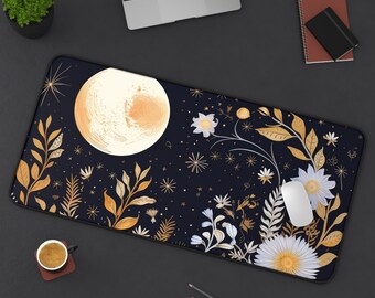 May include: A rectangular mouse pad featuring a celestial design with a large, textured moon and floral elements in gold and white against a dark blue background. A white mouse rests on the pad, with a laptop and other office supplies visible.
