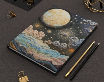 May include: A black notebook with a colorful, embroidered design of a moon, stars, and clouds. The design is reminiscent of a night sky.