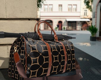 May include: A black and brown travel duffel bag with a geometric pattern. The bag has a brown leather strap and a top handle.