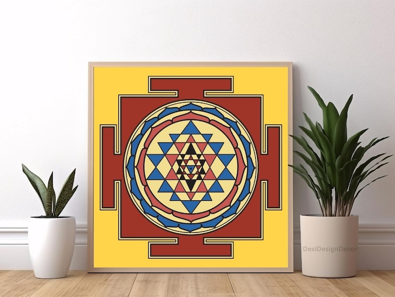 May include: A yellow, red, blue, and black geometric mandala design with a square frame. The design is a Sri Yantra, a sacred symbol in Hinduism.