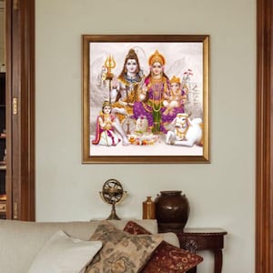 May include: A framed painting depicting a Hindu deity family. The painting features Shiva, Parvati, Ganesha, and a white cow. The painting is set against a white background with a mountain range in the distance.