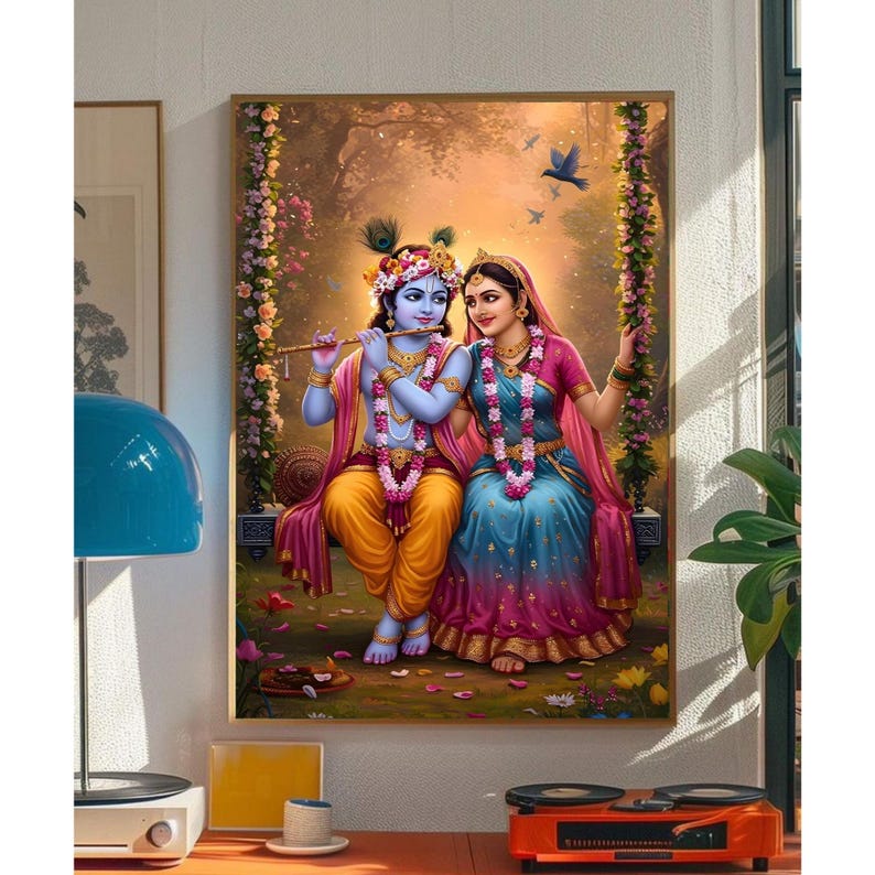 May include: A framed artwork showing two figures in traditional Indian dress on a floral swing. One figure plays a flute. The painting uses vibrant colours, set against a soft, natural background, evoking a sense of peace and serenity.