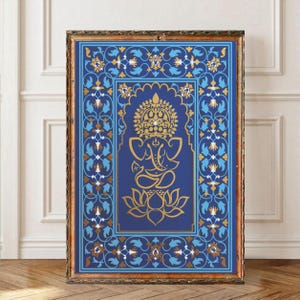 May include: A rectangular framed wall art piece featuring a central gold line drawing of the deity Ganesha seated on a lotus flower. The design is set against a deep blue background with an intricate border of light blue and gold floral motifs.