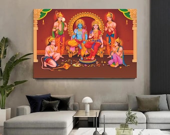 May include: A colorful painting depicting Hindu deities, including Rama, Sita, Lakshmana, and Hanuman. The deities are depicted in a seated position, with Rama and Sita on a throne, Lakshmana standing behind them, and Hanuman kneeling in front. The painting is set against a red background with gold accents.