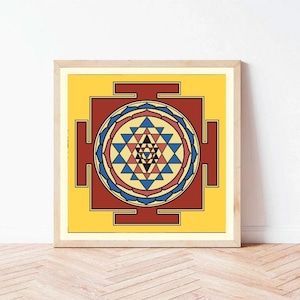 May include: A framed print of a colorful geometric design, known as a Sri Yantra, with a yellow background, red and blue accents, and a central star.