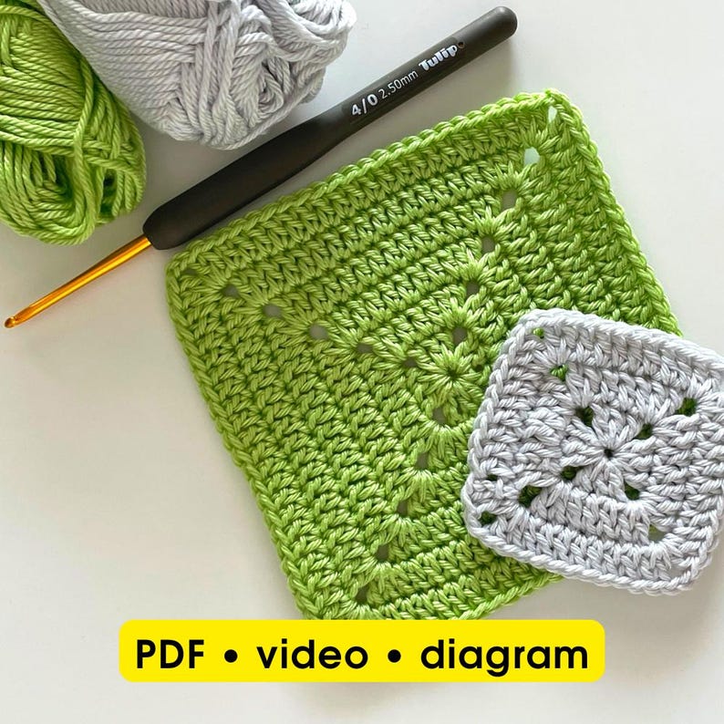 May include: A close-up of crochet supplies, including a green and gray yarn, a crochet hook, and two crocheted squares. The squares are in light green and gray. The text "PDF • video • diagram" is at the bottom.