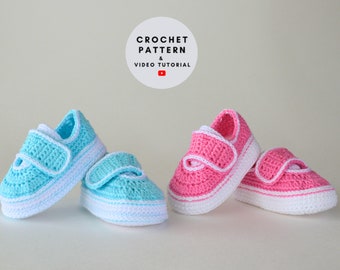 May include: Two pairs of crocheted baby shoes, one pair in pink and one pair in blue. The shoes have white trim and velcro closures.