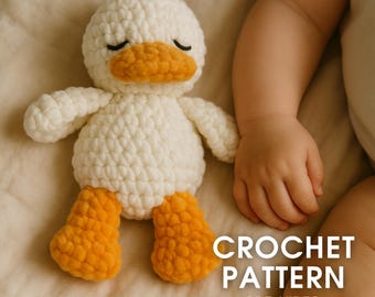 May include: A white and orange crochet duck toy with closed eyes. The duck has a white body, orange beak and feet, and black eyes. The text "CROCHET PATTERN PDF+VIDEO" is in the lower right corner.
