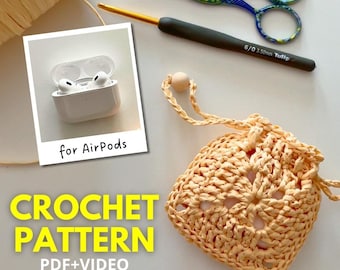 May include: Crochet pattern for an AirPods case. The case is a light peach color and is made with a crochet stitch. The pattern includes a PDF and video instructions. The image also shows a pair of AirPods in a white case, a crochet hook, and a pair of scissors.