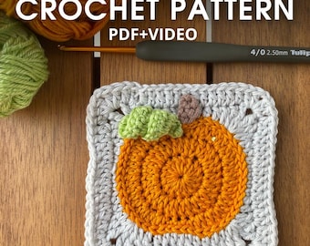 May include: A crocheted square with an orange pumpkin design, green leaves, and a brown stem. The square is bordered in gray yarn. The text "CROCHET PATTERN PDF+VIDEO" is at the top. A crochet hook is visible.