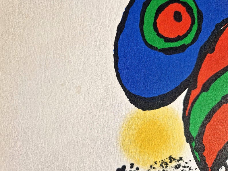 May include: Abstract art print featuring bold shapes and colors. The artwork showcases a blue, red, and green design with black outlines and a yellow circle on a white background. The print has a textured paper appearance.