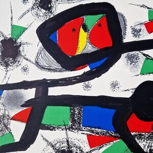 May include: Abstract art print featuring a black, red, green, blue, and yellow design on a white background. The print has a bold, graphic style and is reminiscent of modern art.