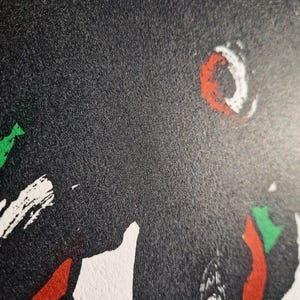 May include: Abstract art print with a textured black background. The artwork features bold brushstrokes in red, white, and green. The composition includes a white crescent shape with a red outline.