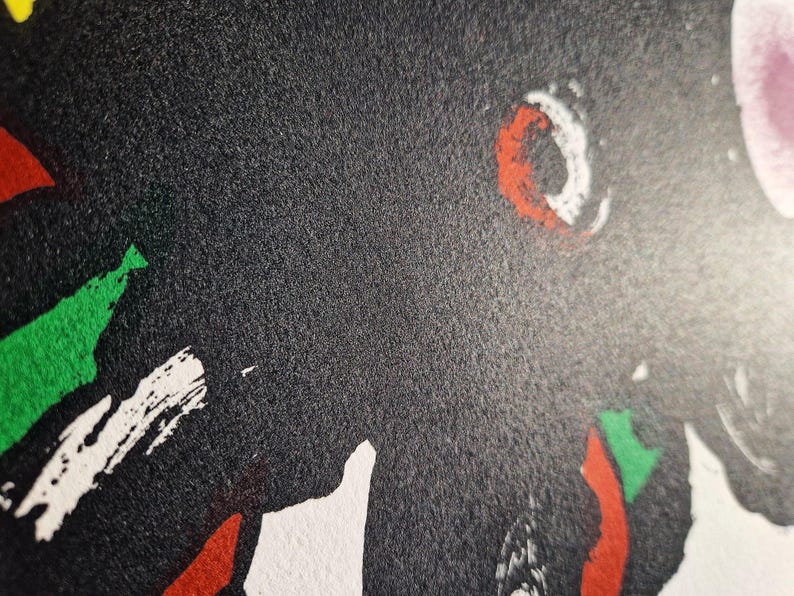 May include: Abstract art print with a textured black background. The artwork features bold brushstrokes in red, white, and green. The composition includes a white crescent shape with a red outline.