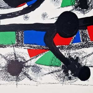 May include: Abstract art print featuring bold black lines, geometric shapes, and splashes of red, green, blue, and yellow on a white background.