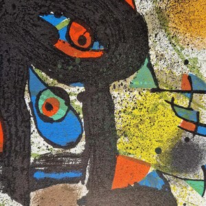 May include: Abstract artwork featuring a black, textured form with orange, blue, and green accents. Splatters of yellow and black paint add to the artistic composition. The artwork is on a white background.