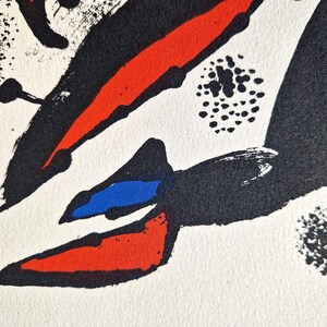 May include: Abstract artwork with bold brushstrokes in red, black, and blue against a white background. The composition features dynamic shapes and textures, creating a visually striking piece. The artwork evokes a sense of movement and energy.