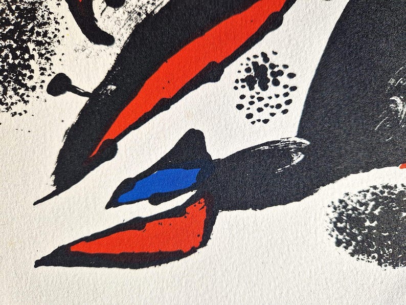 May include: Abstract artwork with bold brushstrokes in red, black, and blue against a white background. The composition features dynamic shapes and textures, creating a visually striking piece. The artwork evokes a sense of movement and energy.