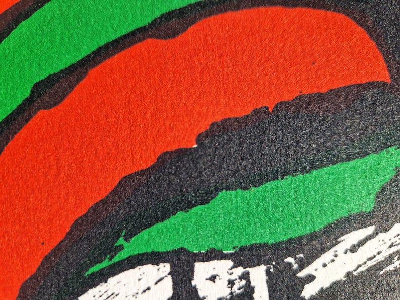 May include: Abstract design with bold strokes of red, green, and black. The image features a textured surface with a dynamic composition of overlapping shapes. White brushstrokes are visible at the bottom. The artwork has a modern, graphic feel.