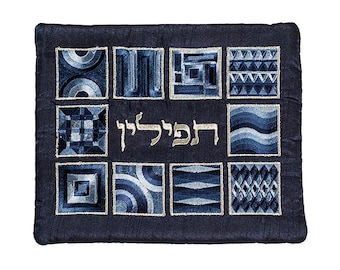 May include: A blue velvet prayer shawl with a Hebrew inscription and geometric patterns in shades of blue and silver.