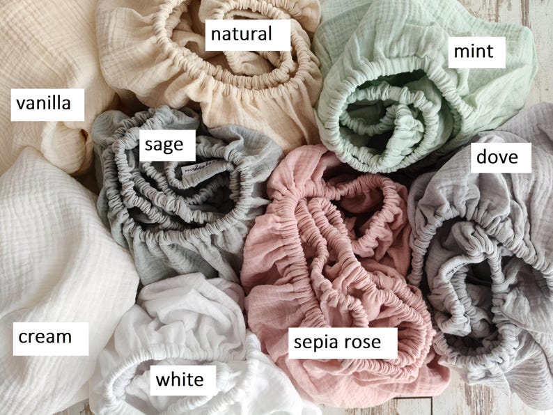 It shows fitted crib sheets made of organic muslin cotton. Perfect for baby oval or bedside cribs, bassinets and cradle. It's cozy pastel baby nursery, ideal for all Stokke cribs.