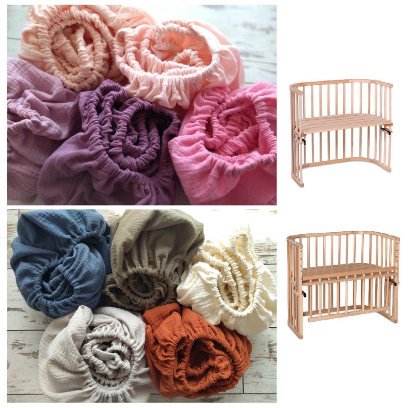May include: A collection of gathered, elasticized fabric sheets in various colors including peach, purple, pink, blue, olive, cream, and rust, displayed alongside two wooden cribs with slatted sides and adjustable height platforms.