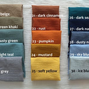 May include: A collection of 15 fabric swatches in various colors, including beige, green khaki, dusty green, light teal, grey, dark cinnamon, rust, pumpkin, mustard, soft yellow, dark sea, dark navy, dusty navy, sky blue, and ice blue. Each swatch is labeled with a number and color name.