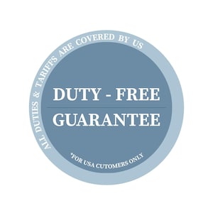 May include: A circular blue badge featuring white text that reads DUTY - FREE GUARANTEE in the center. The outer border contains the text ALL DUTIES & TARIFFS ARE COVERED BY US, and the bottom includes the text *FOR USA CUTOMERS ONLY.