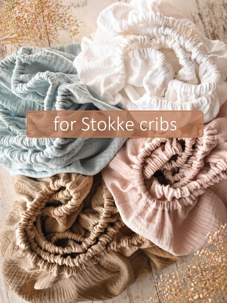 It shows fitted crib sheets made of organic muslin cotton. Perfect for baby oval or bedside cribs, bassinets and cradle. It's cozy pastel baby nursery, ideal for all Stokke cribs.