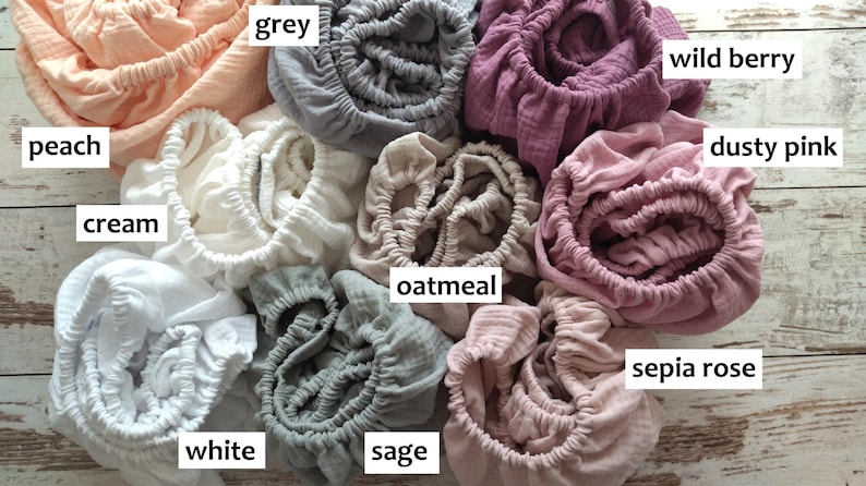 It shows fitted crib sheets made of organic muslin cotton. Perfect for baby oval or bedside cribs, bassinets and cradle. It's cozy pastel baby nursery, ideal for all Stokke cribs.