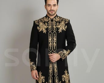 May include: Black formal jacket with intricate gold embroidery. The jacket features long sleeves and a mandarin collar. The matching black pants complete the ensemble. A sophisticated outfit for special occasions.