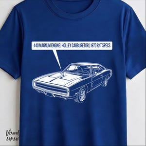 May include: A royal blue t-shirt featuring a white line drawing of a classic car. Above the car is a white rectangle with the text: "440 MAGNUM ENGINE | HOLLEY CARBURETOR | 1970 R/T SPECS". The shirt has short sleeves.