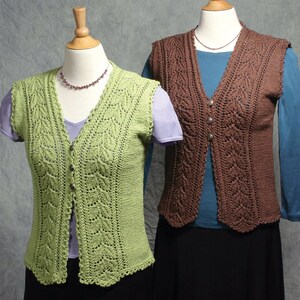 May include: Two sleeveless knitted vests, one green and one brown, displayed on mannequins. Both vests feature a V-neckline and button closures.