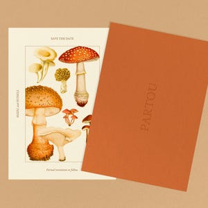 May include: Save the date card with a mushroom illustration. The card is white with brown text that says "Save the Date" and "Formal invitation to follow". The card also has the names "Rachel and Russell" printed vertically on the left side. The illustration features a variety of mushrooms in shades of red, orange, and brown.
