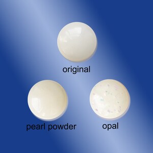 May include: Three white round objects, one plain, one with a pearlescent finish, and one with a glittery opal finish. The objects are labeled "original", "pearl powder", and "opal".