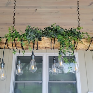 Indoor/Outdoor farmhouse lighting, Log with string lights, bar light  Follow us on Facebook at Lighting Your Way Co.