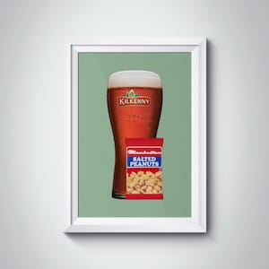 May include: A glass of Kilkenny Irish Cream Stout beer with a bag of Manhattan Salted Peanuts in front of it. The background is a green colour.