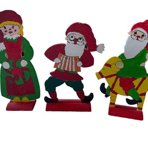 3 pieces of handmade and hand painted Swedish Santa figures in wood. Cut out and painted by hand