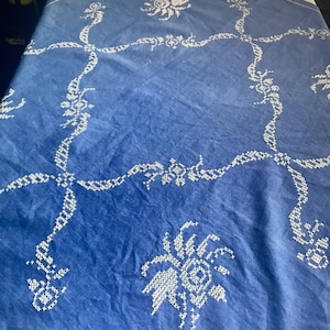 Hand embroidered tablecloth white embroidery on blue background