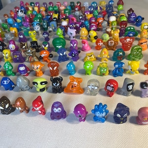100 pcs Crazy Bones Gogos / Dracco Heads and other Mini Monsters Plastic Figures- Vintage