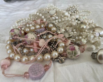 This is a 1/2 pound lot of broken and not, vintage and newer craft jewelry. The majority of these are wearable or for crafts, White tones