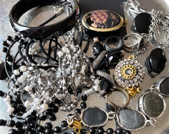 This is a 1/2 pound lot of broken and not, vintage and newer craft jewelry / The majority of these are wearable or used for crafts.