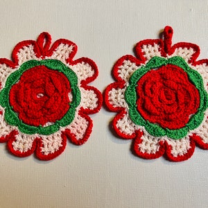 Fine vintage hand crocheted potholders in the shape of a flower. In red white and green hand crocheted in Sweden