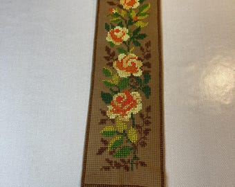 Fine hand-embroidered wall hanging with hanger on top and bottom in brass. Fine hand-embroidered yellow roses