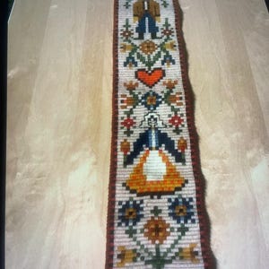 Narrow hand-embroidered wall hanging with hanger, from Sweden