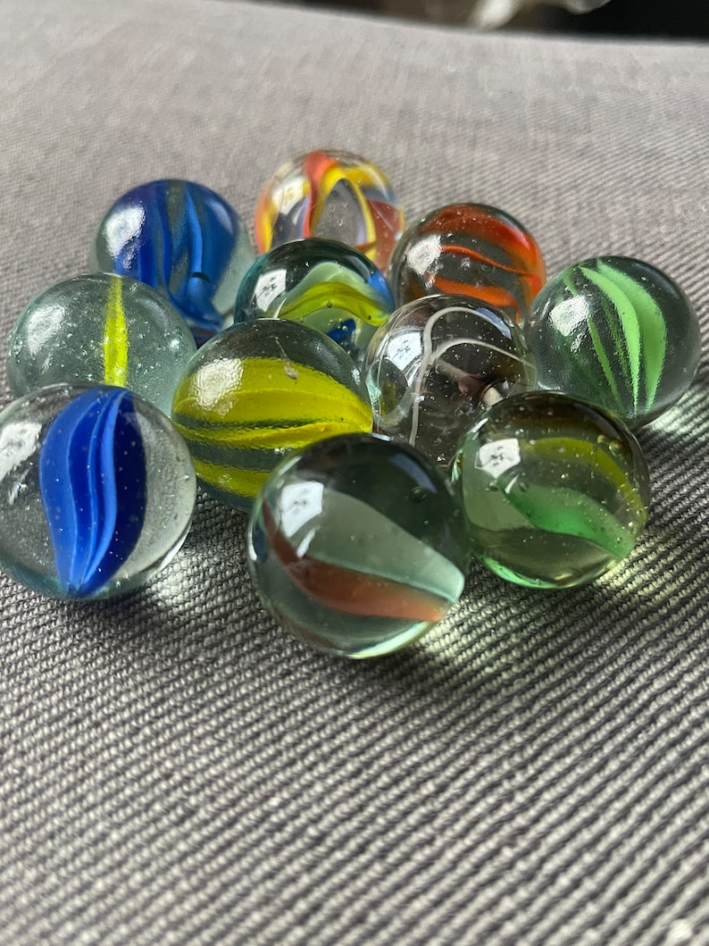 This is a Lot of 3 or 5 Random Vintage Marbles. 5/6