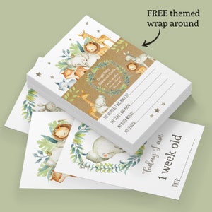 May include: A stack of white cards with a jungle animal theme. The cards are for recording baby milestones. The top card has a brown paper band with the text "Jungle Baby Milestone Cards" and "Even the smallest can change the world". The text on the card reads "The hospital I was born in: The time I was born: My birth weight: My length: Today I am 1 week old. Date:"