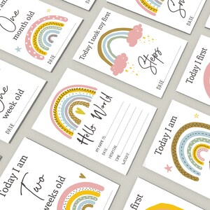 May include: A set of ten rainbow-themed baby milestone cards with colourful rainbows and stars. The cards feature phrases like "Today I am One Week Old" and "Today I Took My First Steps".